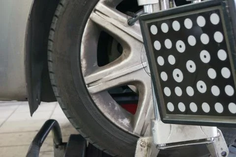 Detail of wheel alignment machine tool mounted on a wheel 库存照片