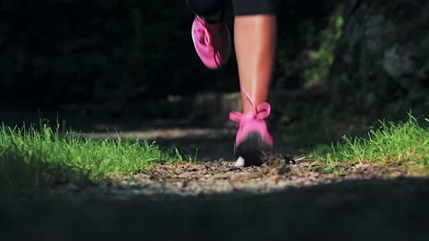 Detail of a woman's shoes while running in nature Stock Footage 157799876