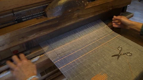 Detail of the work on a textile loom Stock Footage 125948509
