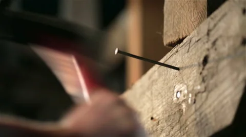 Detail of worker with a nail and a hammer Stock Footage