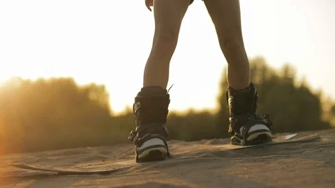 Detail a young beautiful girl hipster athlete in shorts tries doing tricks with Stock Footage