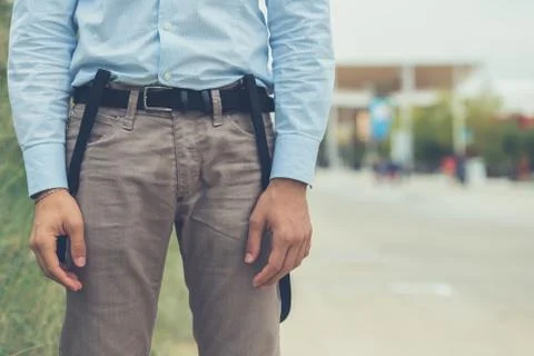 Detail of a young man posing in an urban context Stock Photos