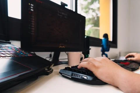 Detail of a young man's hands using a laptop keyboard working as a programmer Stock Photos