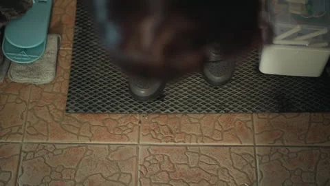 Detailed analysis of shoes and walking style conducted. Thorough inspection of Stock Footage 346561973