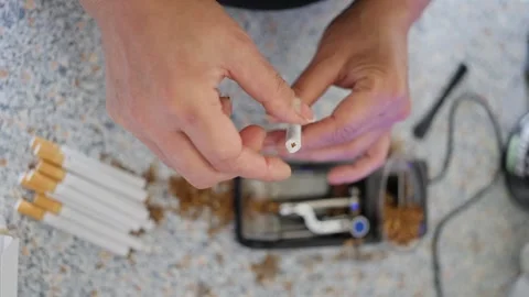 Detailed assembly instructions, workshop scene showing careful handling of vape Stock Footage 321302451