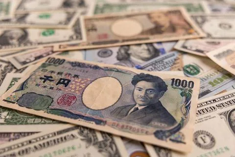 Detailed backdrop of mixed US dollar and Japanese yen banknotes Stock Photos