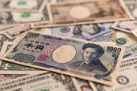 Detailed backdrop of mixed US dollar and Japanese yen banknotes Stock Photos
