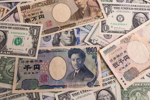 Detailed backdrop of mixed US dollar and Japanese yen banknotes Stock Photos