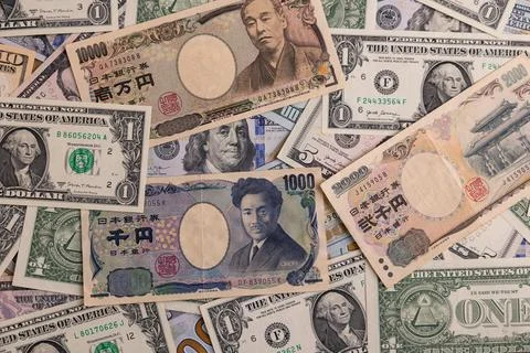 Detailed backdrop of mixed US dollar and Japanese yen banknotes Stock Photos
