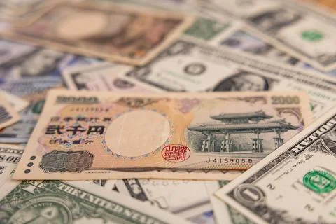 Detailed backdrop of mixed US dollar and Japanese yen banknotes Stock Photos