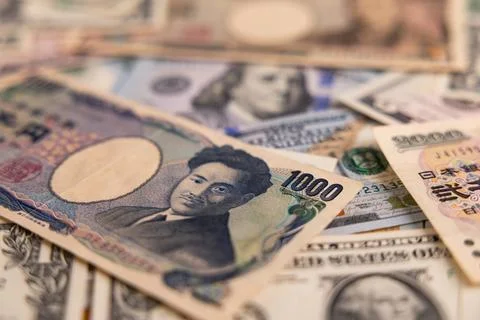 Detailed backdrop of mixed US dollar and Japanese yen banknotes Stock Photos