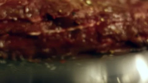 Detailed beef browning in butter inside a dark skillet in portrait, 4K Stock Footage 341103903