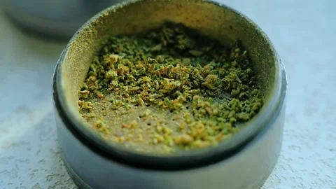Detailed Cannabis Herb Closeup Inside Grinder Container, Green and Orange Colors Stock Footage 318948013