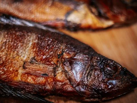 A detailed close-up of dried roach with crispy brown skin lying. Stock Photos