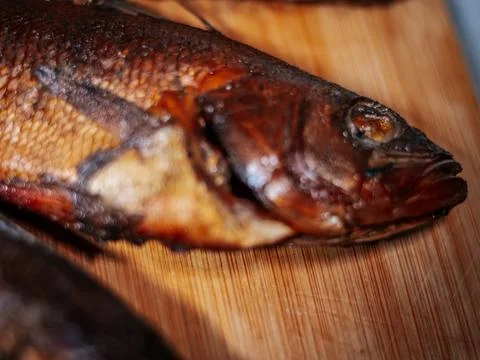 A detailed close-up of dried roach with crispy brown skin lying. Stock Photos