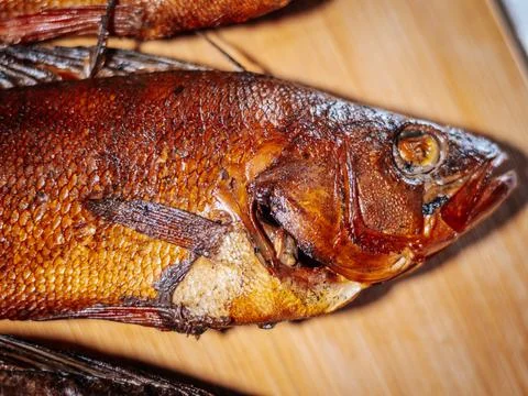 A detailed close-up of dried roach with crispy brown skin lying. Stock Photos