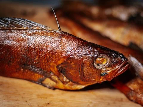 A detailed close-up of dried roach with crispy brown skin lying. Stock Photos