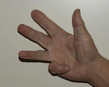 A detailed close-up of an elderly hand gesturing the number four, highlight.. Foto stock