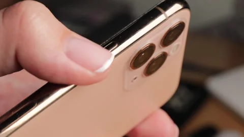 Detailed close-up of a finger pressing the side button on a modern smartpho.. Stock Footage 320738705