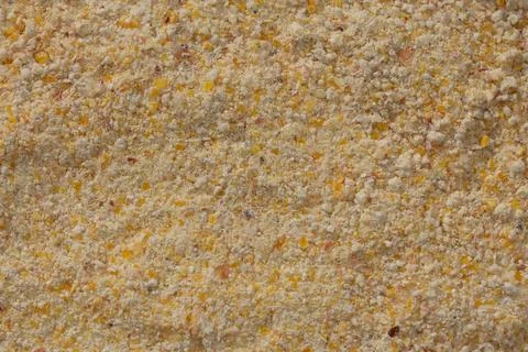 A detailed close-up of a ground mixture of corn, rye, and barley. The image.. Stock Photos