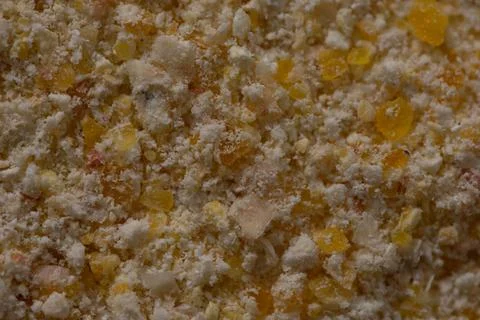 A detailed close-up of a ground mixture of corn, rye, and barley. The image.. Stock Photos