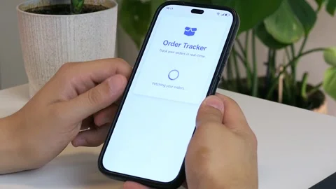 Detailed close-up of hands tracking a shipment via smartphone - shows complete Stock Footage 314516783
