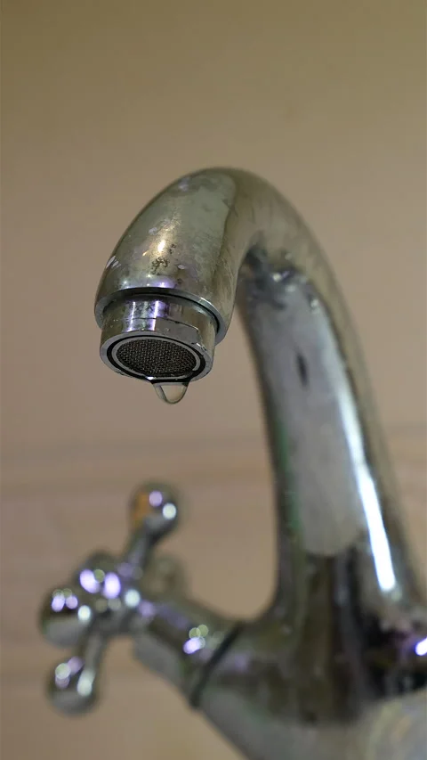 A Detailed Close-Up Image Featuring A Metallic Faucet With A Visible Water Dropl Stock Footage 302540836