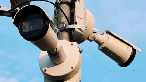 Detailed close-up of an outdoor CCTV camera array mounted on a pole. Modern Video stock 329296157