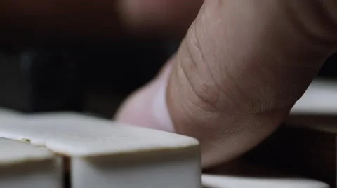 Detailed close up shot of thumb hitting a piano key Stock Footage 65401810