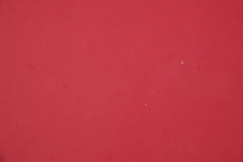 Detailed close up shows a solid, bright red surface, possibly paint Foto stock