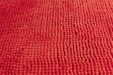 Detailed close up texture of soft red textile material with raised pattern Stock Photos