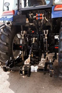 Detailed close up of tractor mechanical components and hitch system for farmi Foto stock