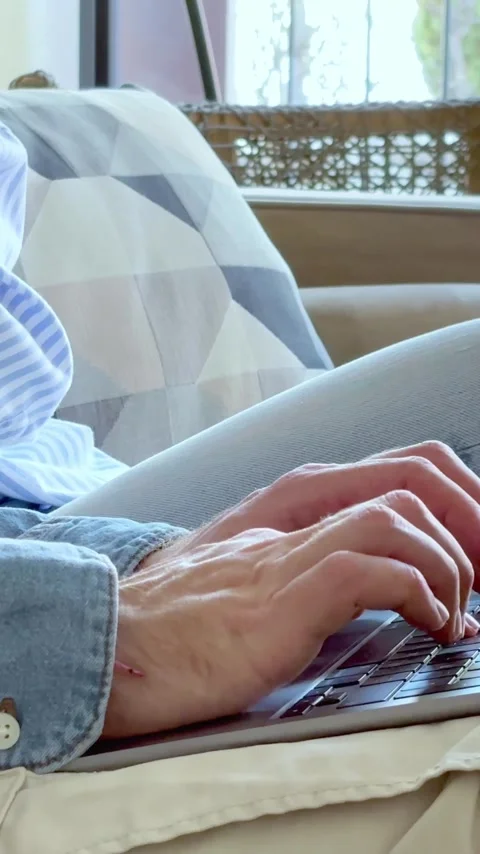 Detailed close-up view of a man's hands typing on a laptop, working remotely Stock Footage 347191055