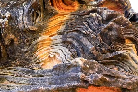 A detailed close-up view of patterned layers in a natural rock formation Stock Photos