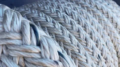 Detailed close-up view of a thick braided rope on military warship showing it Stock Footage 297438523