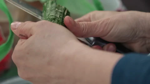 Detailed closeup of cucumber peeling and texture focus. Focused shot of hands Stock Footage 341662995