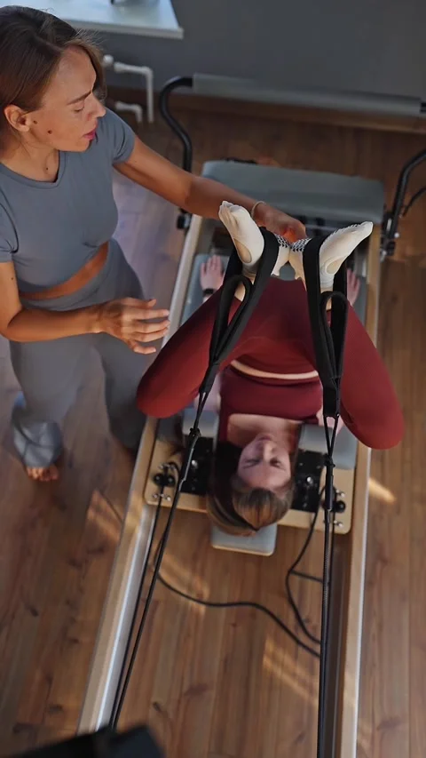 A detailed closeup of a foot work and core exercise on a Balanced Body Reformer Stock Footage 341735670
