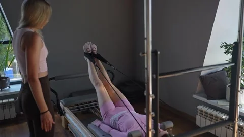 A detailed closeup of a foot work and core exercise on Body Reformer machine Stock Footage 346285618