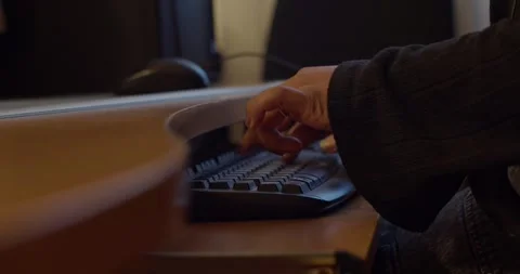 A Detailed CloseUp of Hands Engaged in Typing on a Computer Keyboard at a Stock Footage 310519862