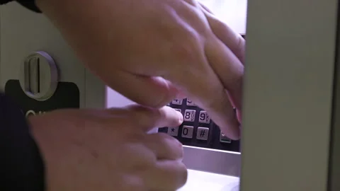 Detailed CloseUp of Hands Skillfully Using a Numeric Keypad on a Secured Locking Stock Footage 283530913