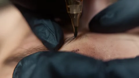 Detailed closeup of microblading procedure creating natural hairstrokes for Video stock 332058191