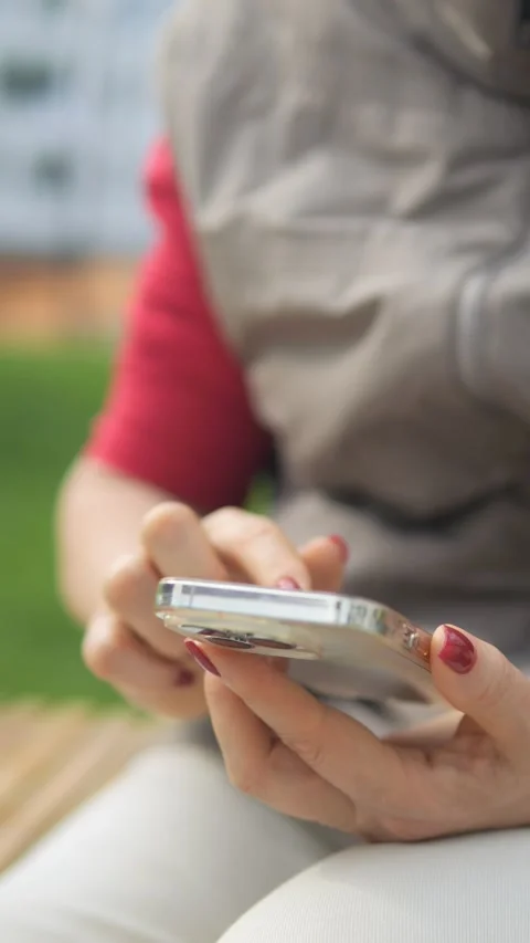 A Detailed Closeup of a Person Happily Using a Smartphone While Outdoors in Stock Footage 285948444