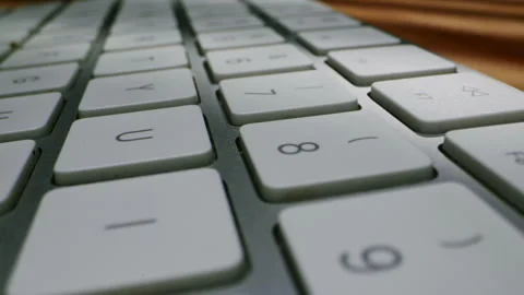A detailed closeup shot of a sleek and modern computer keyboard showing the keys Stock Footage 288117416