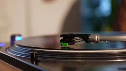 A Detailed CloseUp of a Turntable Actively Playing a Vinyl Record for Music Video stock 314576445