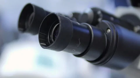 A Detailed CloseUp View of a Laboratory Microscope, Showcasing Its Features and Stock Footage 295943535