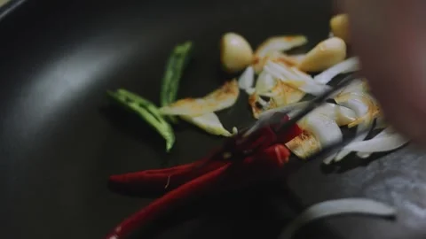 Detailed culinary close-up: stirring peppers onion and garlic in oil Stock Footage 342179552