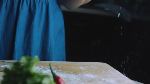 Detailed culinary scene: dusting green dough with flour Stock Footage 342173450
