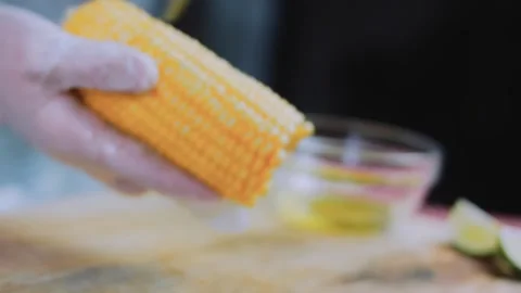 Detailed culinary study: arranging grilled corn on a plate Stock Footage 342171004