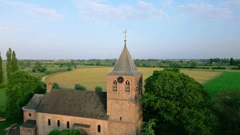 Detailed drone view of Oosterbeek Old Church tower, featuring its clock and Stock Footage 336470393