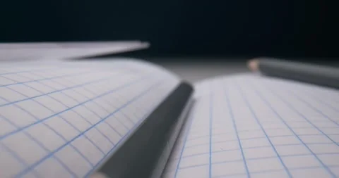 Detailed extreme close-up checkered notebook with pencils and compasses Stock Footage 152632255